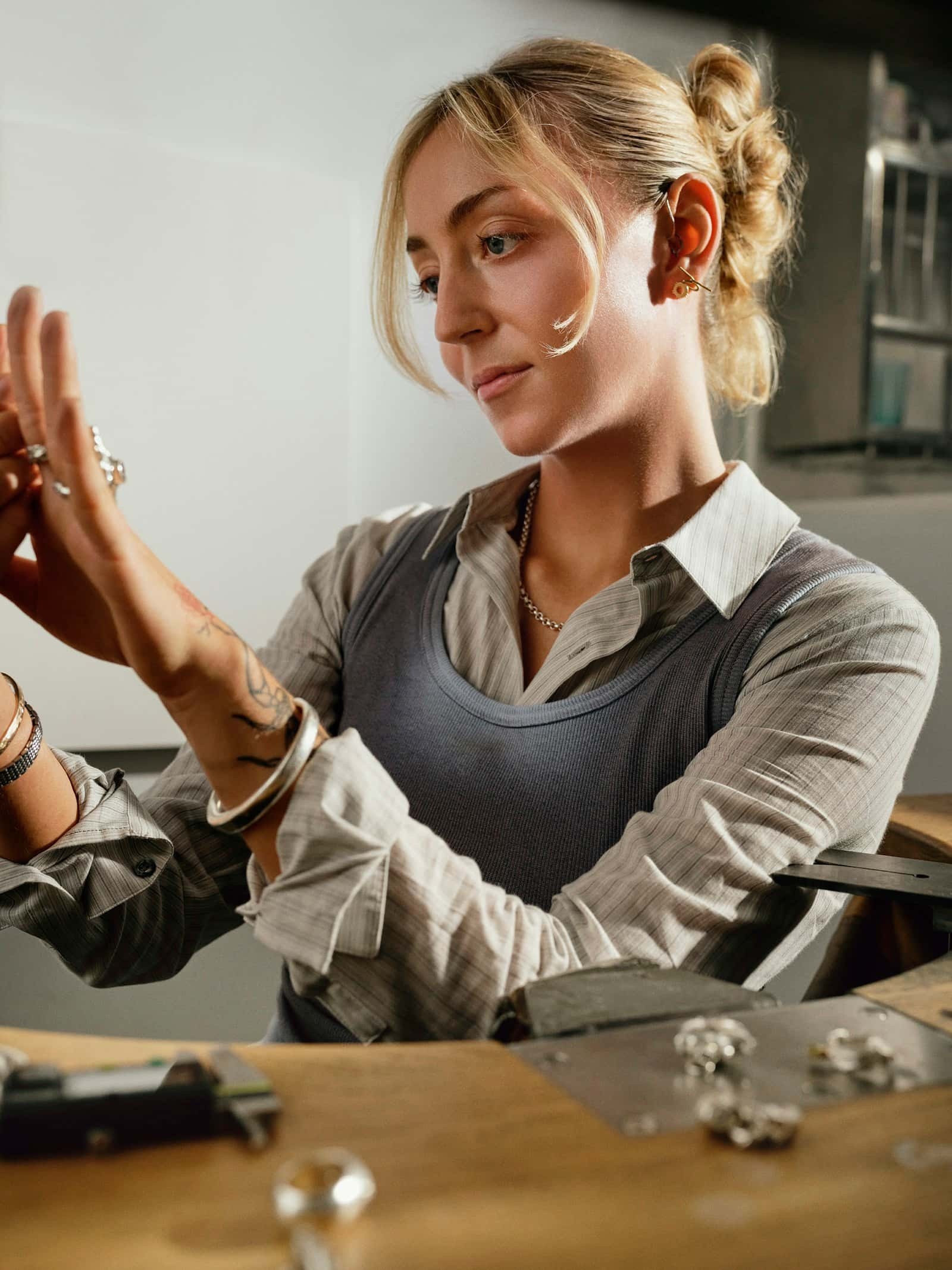 Jeweler examining a gemstone through a loupe in the atelier
